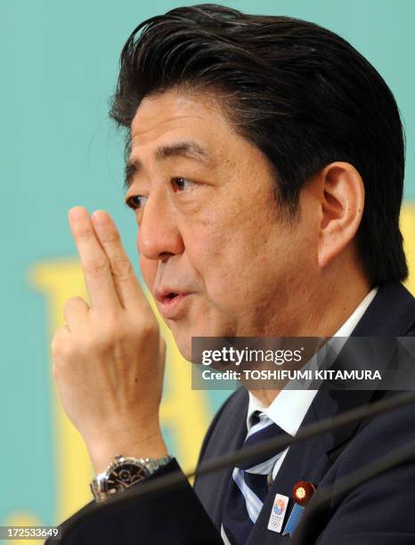 Japanese Prime Minister and ruling Liberal Democratic Party leader Shinzo Abe answers a question during their political debate with other party...