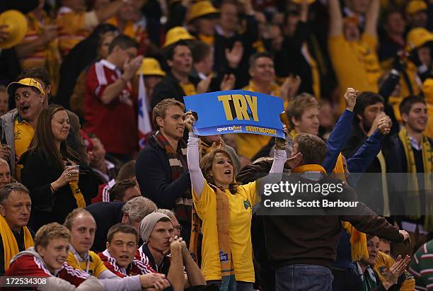 Wallabies supporters celebrate in the crowd as Adam Ashley-Cooper of the Wallabies celebrates after scoring a try during game two of the...