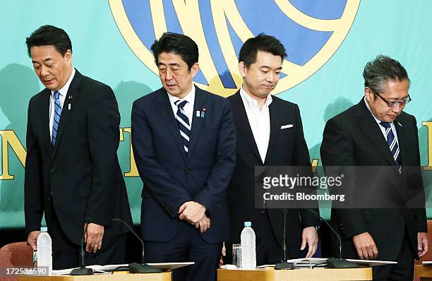 Banri Kaieda, president of the Democratic Party of Japan , from left, Shinzo Abe, Japan's prime minister and president of the Liberal Democratic...