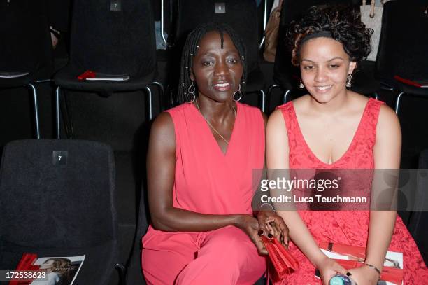 Auma Obama and her daughter Akini at the Minx By Eva Lutz Show during the Mercedes-Benz Fashion Week Spring/Summer 2014 at the Brandenburg Gate on...