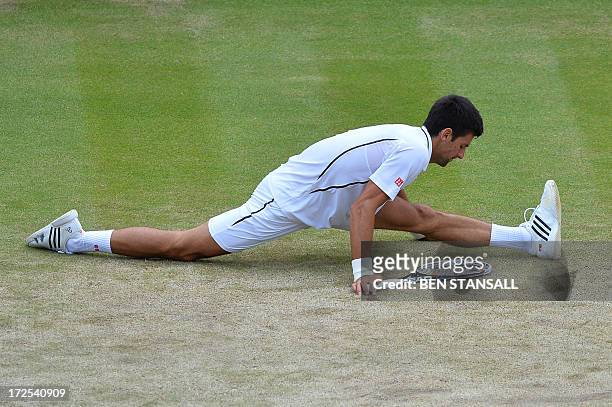Serbia's Novak Djokovic does the slips after reaching for a return against Czech Republic's Tomas Berdych during their men's singles quarter-final...