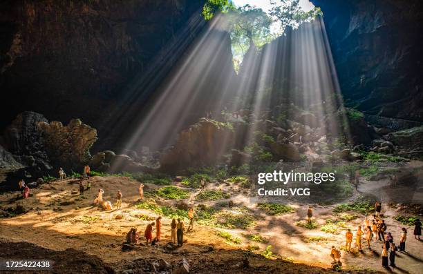 Sunlight scatters as it passes through the giant karst sinkhole, also called tiankeng, or "heavenly pit", on October 6, 2023 in Hechi, Guangxi Zhuang...