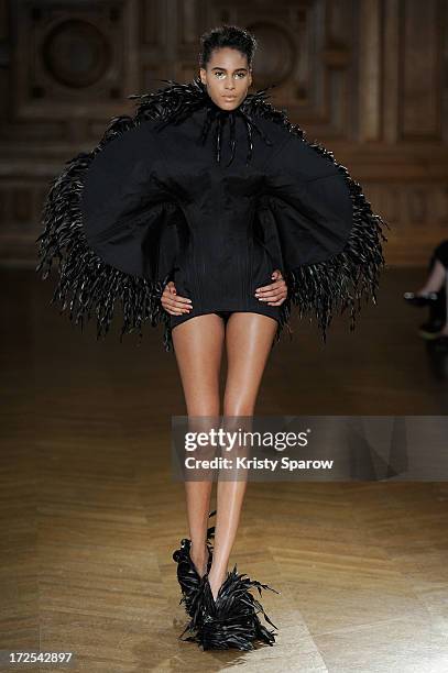 Model walks the runway during the Serkan Cura Couture show as part of Paris Fashion Week Haute-Couture Fall/Winter 2013-2014 at Mairie du 4e on July...