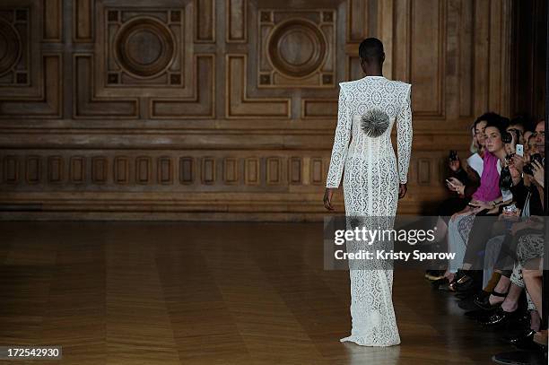 Model walks the runway during the Serkan Cura Couture show as part of Paris Fashion Week Haute-Couture Fall/Winter 2013-2014 at Mairie du 4e on July...