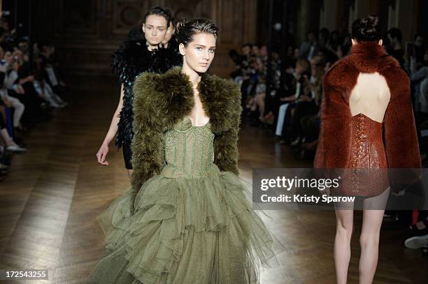 Models walk the runway during the Serkan Cura Couture show as part of Paris Fashion Week Haute-Couture Fall/Winter 2013-2014 at Mairie du 4e on July...