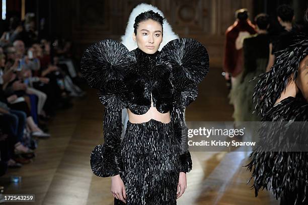 Models walk the runway during the Serkan Cura Couture show as part of Paris Fashion Week Haute-Couture Fall/Winter 2013-2014 at Mairie du 4e on July...