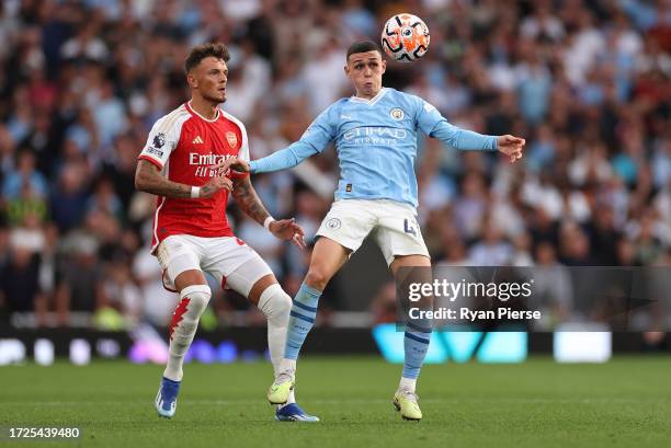 Phil Foden of Manchester City competes for the ball against Ben White of Arsenal during the Premier League match between Arsenal FC and Manchester...