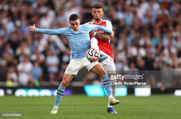 Phil Foden of Manchester City competes for the ball against Ben White of Arsenal during the Premier League match between Arsenal FC and Manchester...