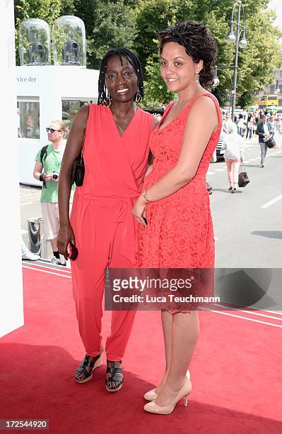 Auma Obama and her daughter Akini attend the Minx By Eva Lutz Show during the Mercedes-Benz Fashion Week Spring/Summer 2014 at the Brandenburg Gate...