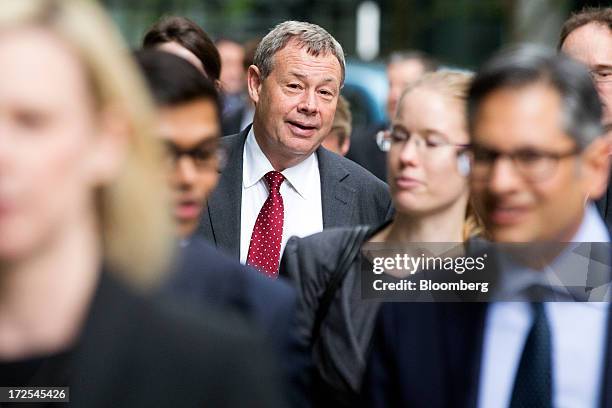 Ian Hannam, former global chairman of equity capital markets at JPMorgan Chase & Co., center, arrives to give evidence at the High Court in London,...