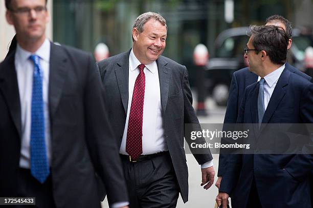 Ian Hannam, former global chairman of equity capital markets at JPMorgan Chase & Co., center, arrives to give evidence at the High Court in London,...