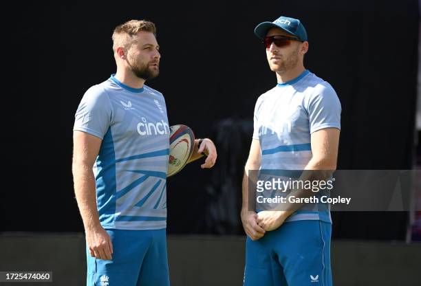 England captain Jos Buttler speaks with selector Luke Wright during a nets session at Himachal Pradesh Cricket Association Stadium on October 09,...