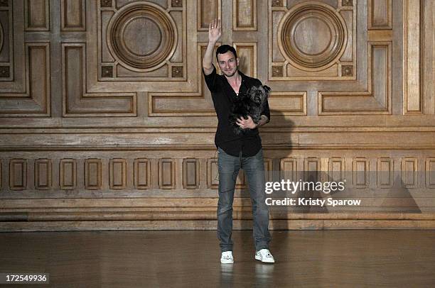 Serkan Cura acknowledges the audience during the Serkan Cura Couture show as part of Paris Fashion Week Haute-Couture Fall/Winter 2013-2014 at Mairie...