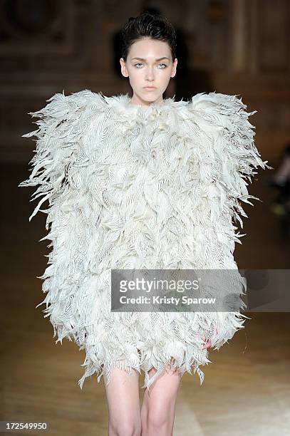 Model walks the runway during the Serkan Cura Couture show as part of Paris Fashion Week Haute-Couture Fall/Winter 2013-2014 at Mairie du 4e on July...