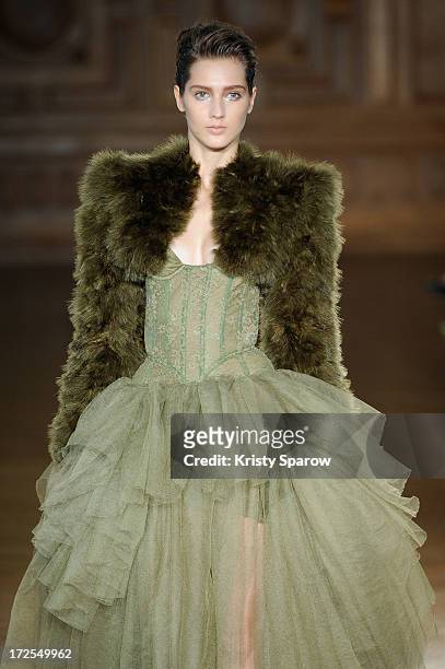 Model walks the runway during the Serkan Cura Couture show as part of Paris Fashion Week Haute-Couture Fall/Winter 2013-2014 at Mairie du 4e on July...