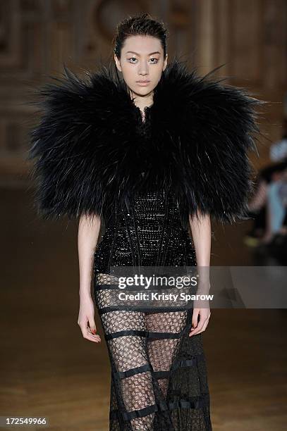 Model walks the runway during the Serkan Cura Couture show as part of Paris Fashion Week Haute-Couture Fall/Winter 2013-2014 at Mairie du 4e on July...