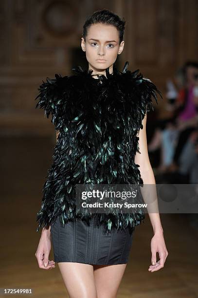 Model walks the runway during the Serkan Cura Couture show as part of Paris Fashion Week Haute-Couture Fall/Winter 2013-2014 at Mairie du 4e on July...