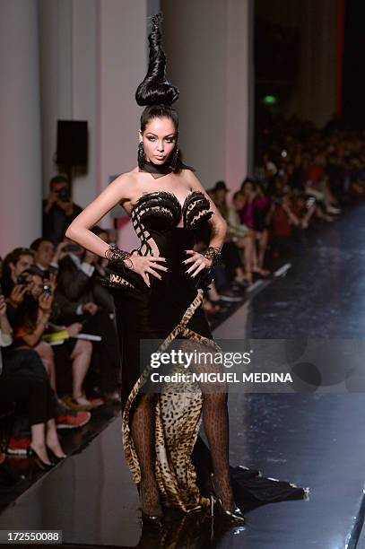 French reality TV star Nabilla Benattia presents a creation by Jean Paul Gaultier during the Haute Couture Fall-Winter 2013/2014 collection show, on...