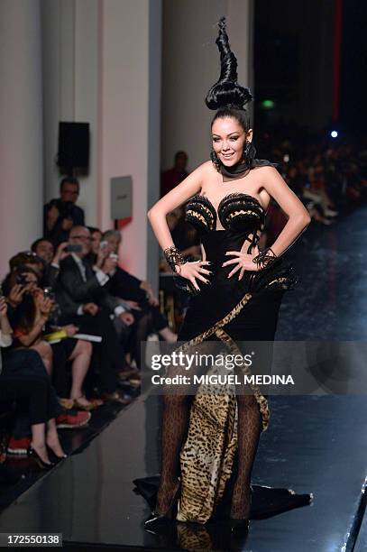 French reality TV star Nabilla Benattia presents a creation by Jean Paul Gaultier during the Haute Couture Fall-Winter 2013/2014 collection show, on...