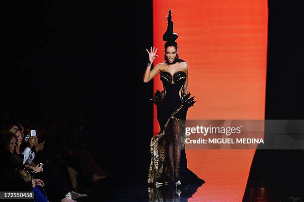 French reality TV star Nabilla Benattia presents a creation by Jean Paul Gaultier during the Haute Couture Fall-Winter 2013/2014 collection show, on...