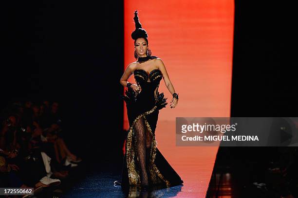 French reality TV star Nabilla Benattia presents a creation by Jean Paul Gaultier during the Haute Couture Fall-Winter 2013/2014 collection show, on...