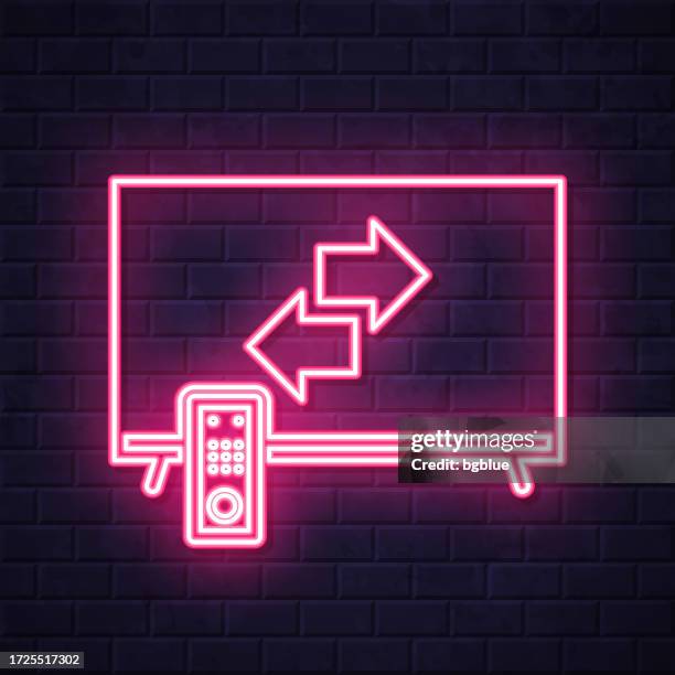 transfer with tv. glowing neon icon on brick wall background - alter tv stock illustrations