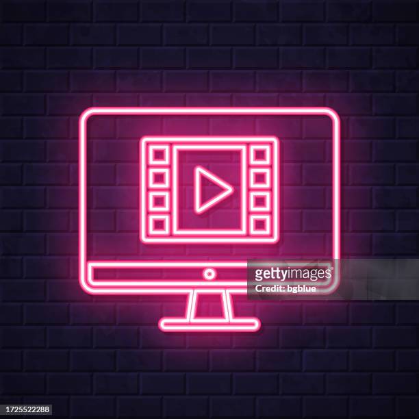 watch video on desktop computer. glowing neon icon on brick wall background - netflix stock illustrations