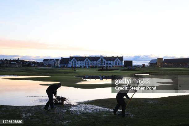 Grounds Staff tend to the course, brushing water on the 18th hole, ahead of Round Three on Day Five of the Alfred Dunhill Links Championship at...