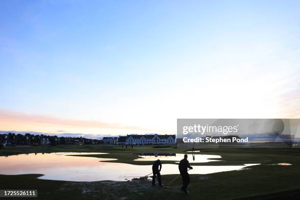 Grounds Staff tend to the course, brushing water on the 18th hole, ahead of Round Three on Day Five of the Alfred Dunhill Links Championship at...