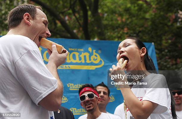 Men's world record holder Joey Chestnut and women's world record holder Sonya Thomas eat a hot dog during the Nathan's Famous Fourth of July...