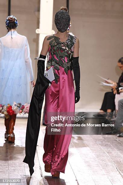 Model walks the runway during the Maison Martin Margiela show as part of Paris Fashion Week Haute-Couture Fall/Winter 2013-2014 at on July 3, 2013 in...