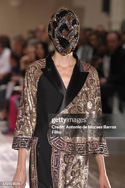 Model walks the runway during the Maison Martin Margiela show as part of Paris Fashion Week Haute-Couture Fall/Winter 2013-2014 at on July 3, 2013 in...