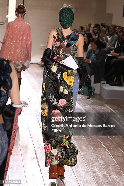 Model walks the runway during the Maison Martin Margiela show as part of Paris Fashion Week Haute-Couture Fall/Winter 2013-2014 at on July 3, 2013 in...