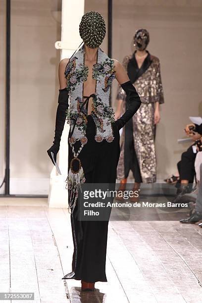Model walks the runway during the Maison Martin Margiela show as part of Paris Fashion Week Haute-Couture Fall/Winter 2013-2014 at on July 3, 2013 in...