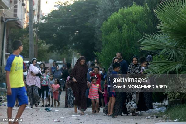 Palestinian families flee their homes following an Israeli attack on the Rafah refugee camp, in the southern of Gaza Strip on Octobers 15, 2023....