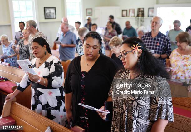 Members of Lahaina United Methodist Church, which was destroyed in a wind-whipped wildfire on August 8th, sing during Sunday services at their...