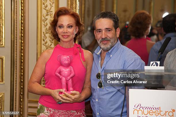 Spanish singer Paloma San Basilio receives from Eladio de Mora "dEmo" the "Muestra-T" 2013 award at the Casa America on July 3, 2013 in Madrid, Spain.