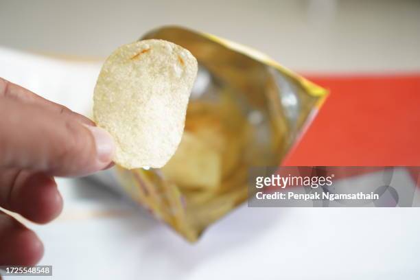 crispy potato chips in a foil bag - chips bag stock pictures, royalty-free photos & images