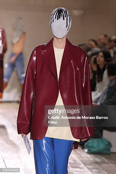 Model walks the runway during the Maison Martin Margiela show as part of Paris Fashion Week Haute-Couture Fall/Winter 2013-2014 at on July 3, 2013 in...