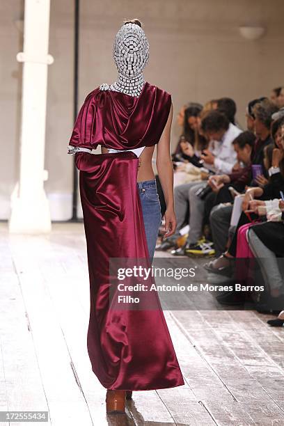 Model walks the runway during the Maison Martin Margiela show as part of Paris Fashion Week Haute-Couture Fall/Winter 2013-2014 at on July 3, 2013 in...