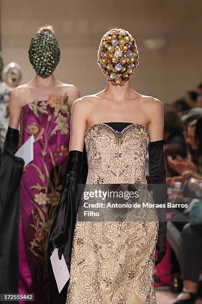 Model walks the runway during the Maison Martin Margiela show as part of Paris Fashion Week Haute-Couture Fall/Winter 2013-2014 at on July 3, 2013 in...