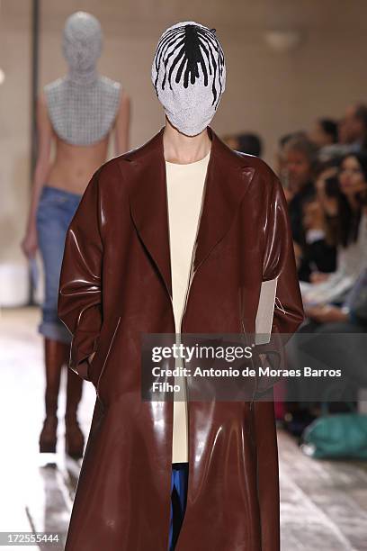 Model walks the runway during the Maison Martin Margiela show as part of Paris Fashion Week Haute-Couture Fall/Winter 2013-2014 at on July 3, 2013 in...