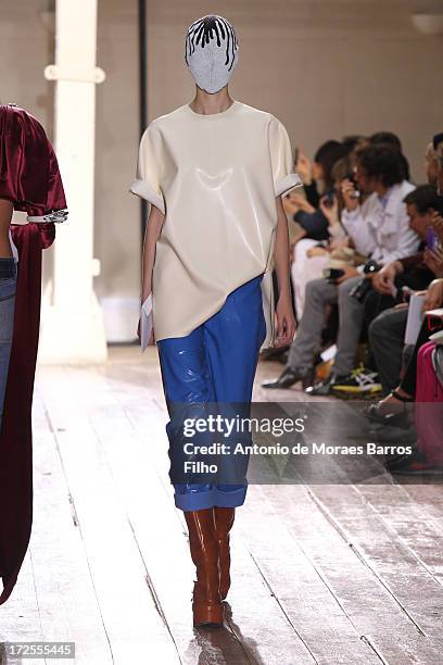 Model walks the runway during the Maison Martin Margiela show as part of Paris Fashion Week Haute-Couture Fall/Winter 2013-2014 at on July 3, 2013 in...