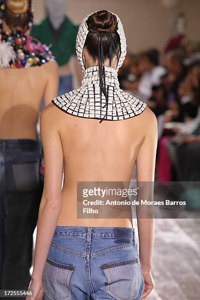 Model walks the runway during the Maison Martin Margiela show as part of Paris Fashion Week Haute-Couture Fall/Winter 2013-2014 at on July 3, 2013 in...