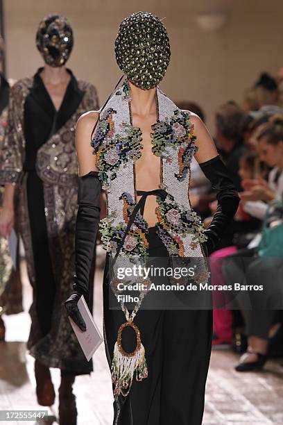 Model walks the runway during the Maison Martin Margiela show as part of Paris Fashion Week Haute-Couture Fall/Winter 2013-2014 at on July 3, 2013 in...