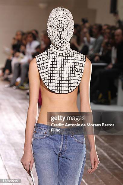 Model walks the runway during the Maison Martin Margiela show as part of Paris Fashion Week Haute-Couture Fall/Winter 2013-2014 at on July 3, 2013 in...