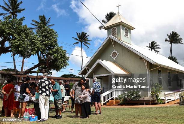 Members of Lahaina United Methodist Church, which was destroyed in a wind-whipped wildfire on August 8th, gather following Sunday services at their...