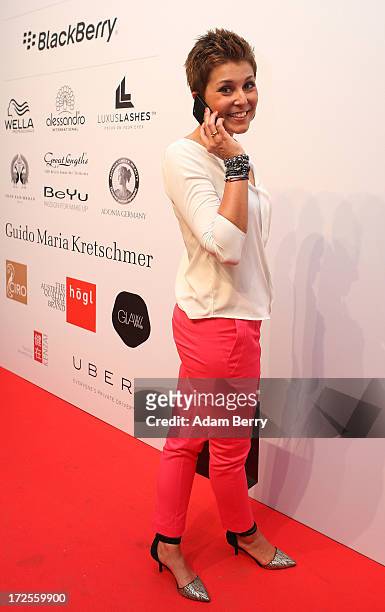 Vanessa Blumhagen poses with a Blackberry Z10 smartphone at the Blackberry Style Lounge during Mercedes-Benz Fashion Week in Berlin on July 3, 2013...