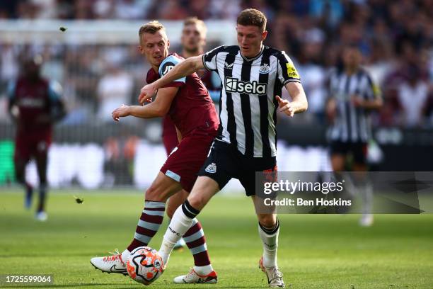 Elliot Anderson of Newcastle holds off pressure from James Ward-Prowse of West Ham during the Premier League match between West Ham United and...