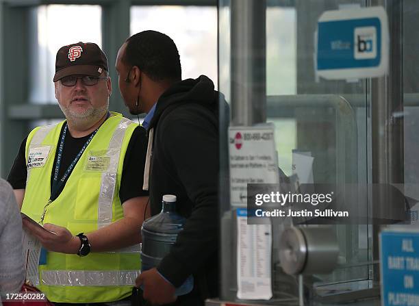 Bay Area Rapid Transit worker Gary Jensen helps a commuter with directions at the Millbrae station on July 3, 2013 in Millbrae, California. For a...